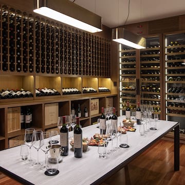 a wine cellar with wine bottles and glasses