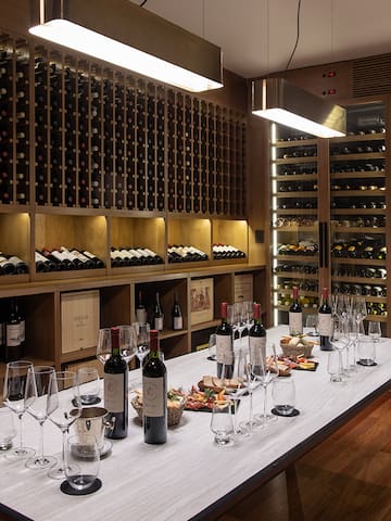 a wine cellar with wine bottles and glasses