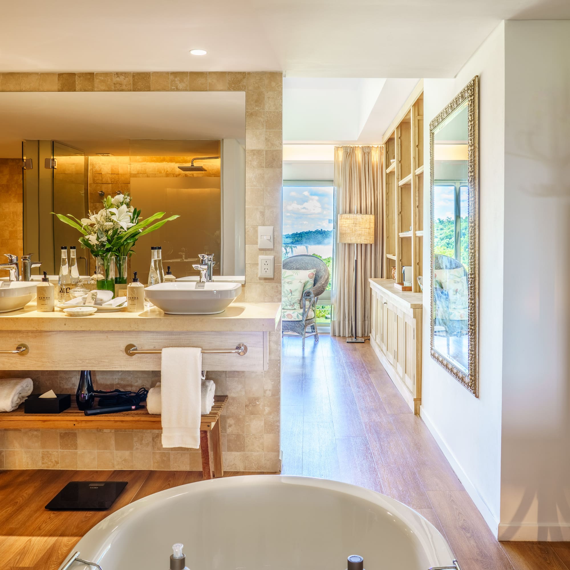 a bathroom with a tub and a large mirror