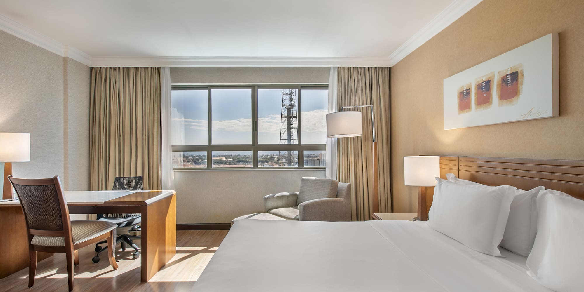 a room with a large bed and a desk