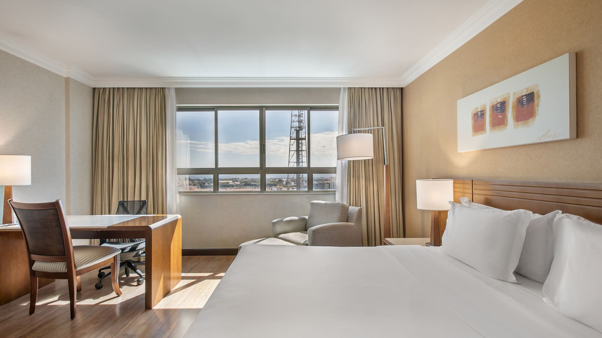 a room with a large bed and a desk