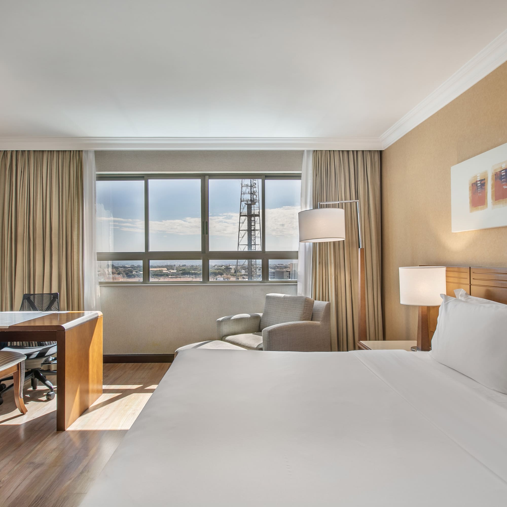 a room with a large bed and a desk