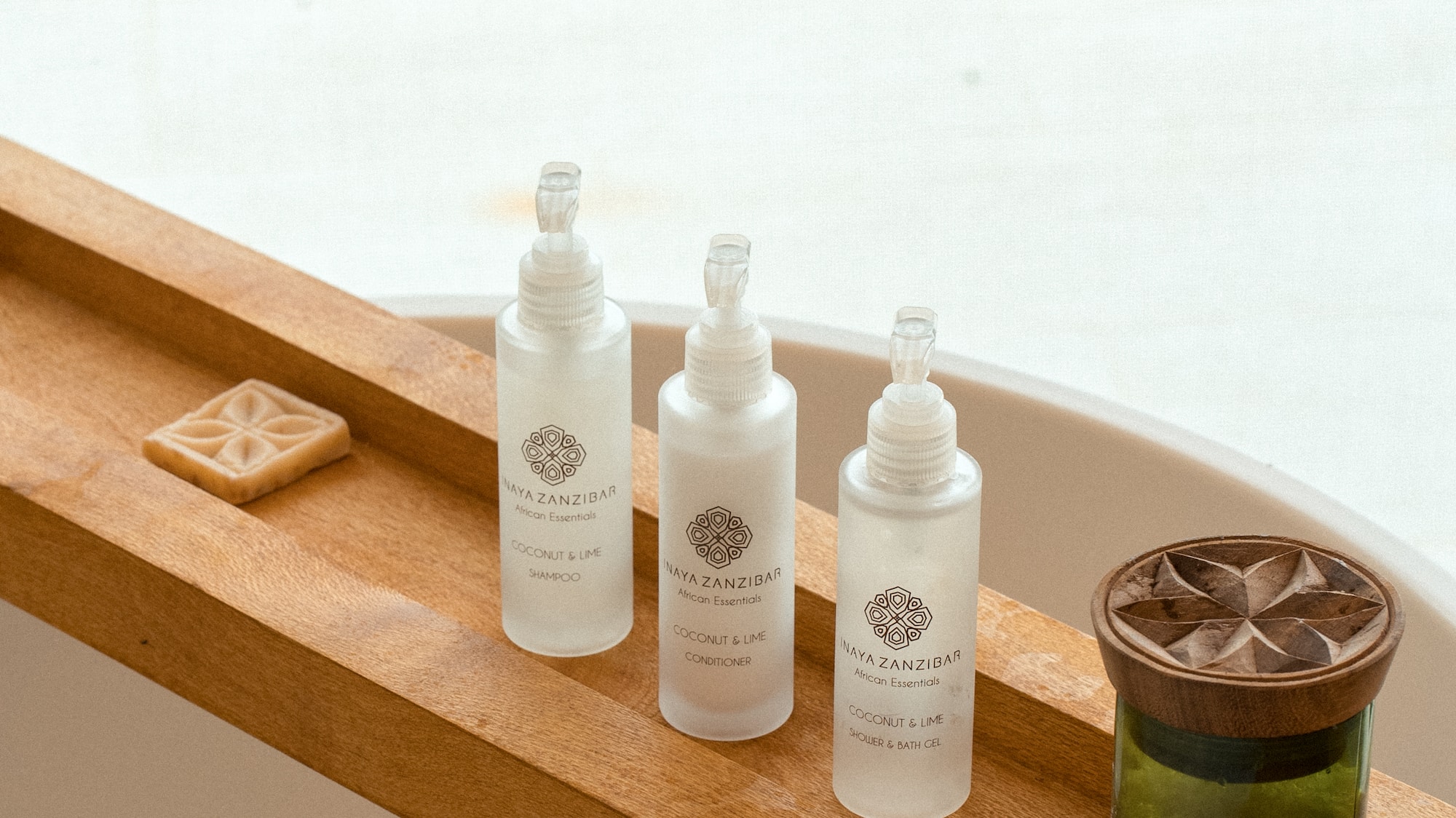 Naya Zanzibar Coconut & Lime bath set with soap on wooden caddy.
