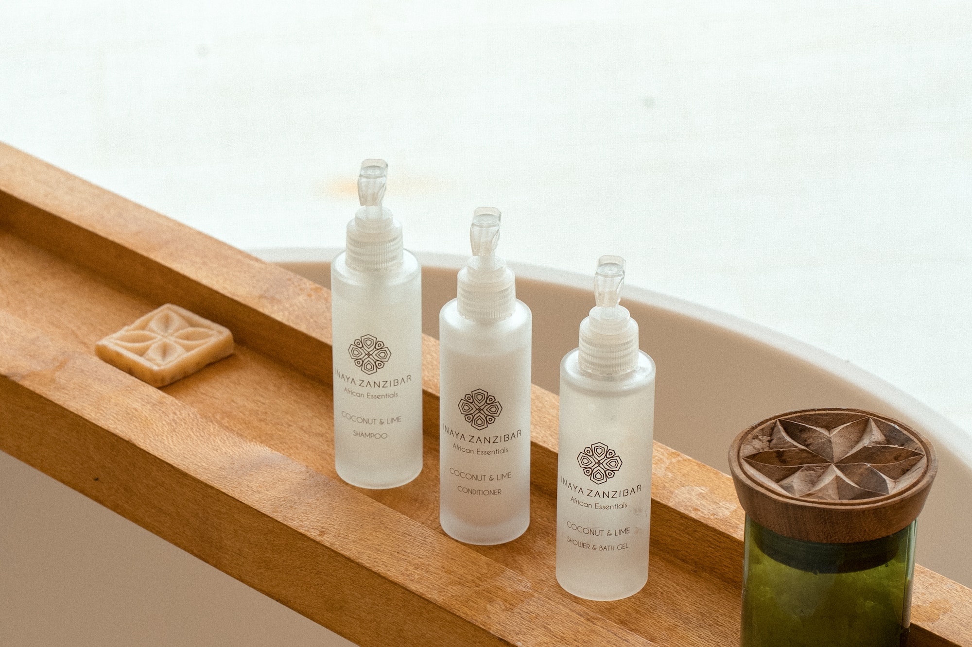 Naya Zanzibar Coconut & Lime bath set with soap on wooden caddy.