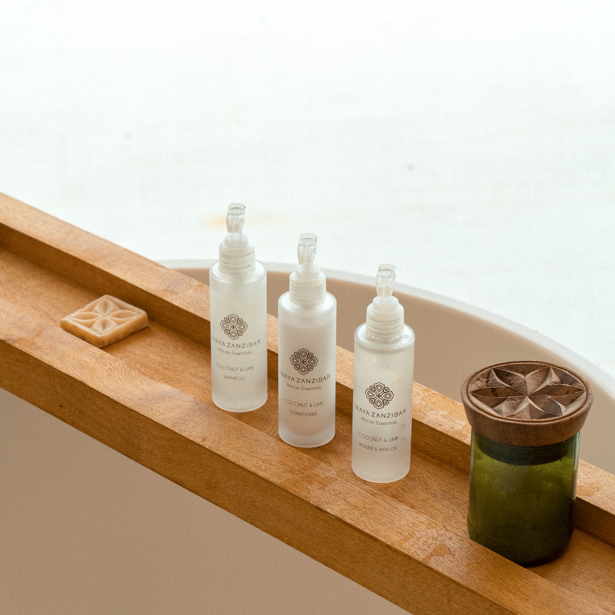 Naya Zanzibar Coconut & Lime bath set with soap on wooden caddy.