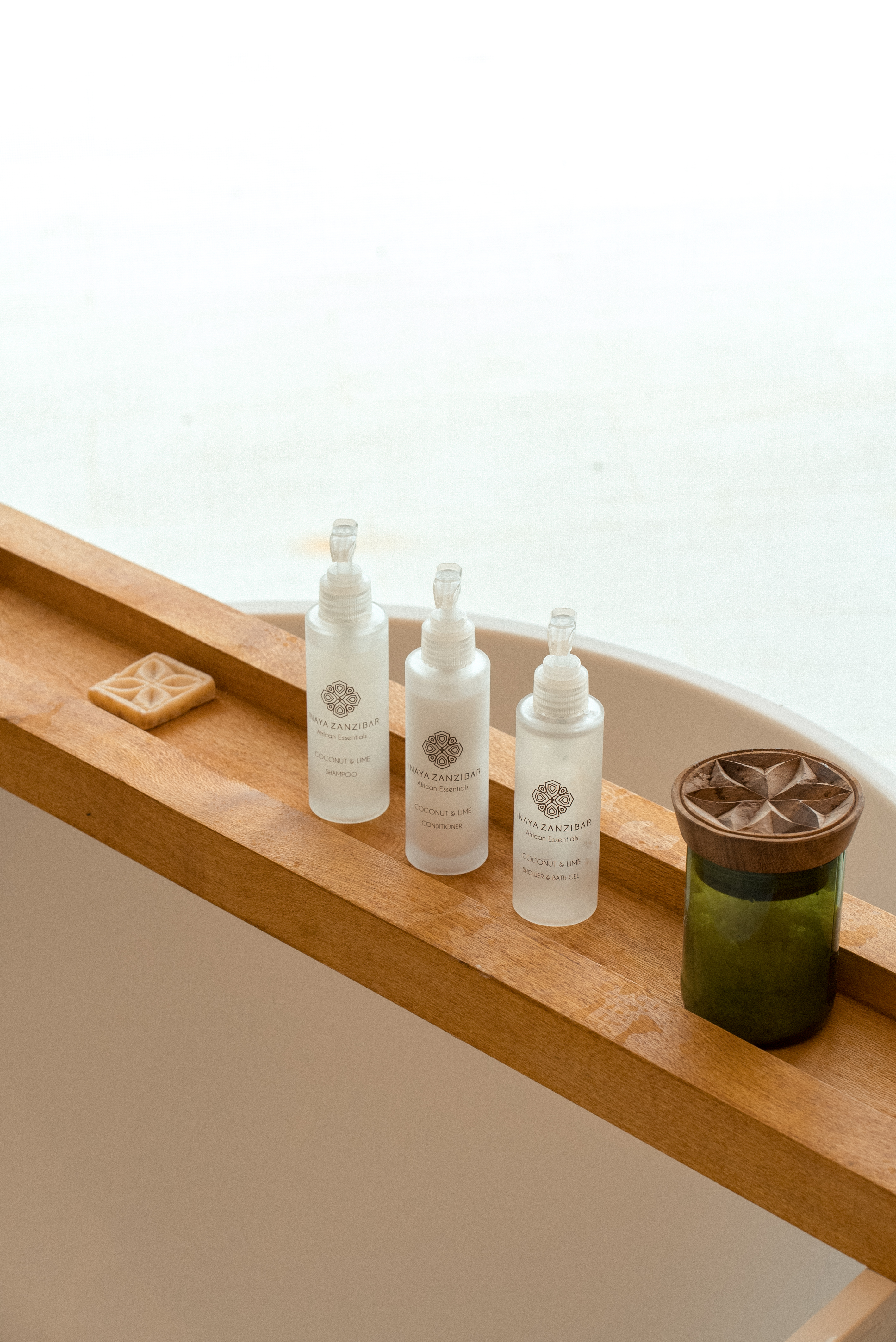Naya Zanzibar Coconut & Lime bath set with soap on wooden caddy.