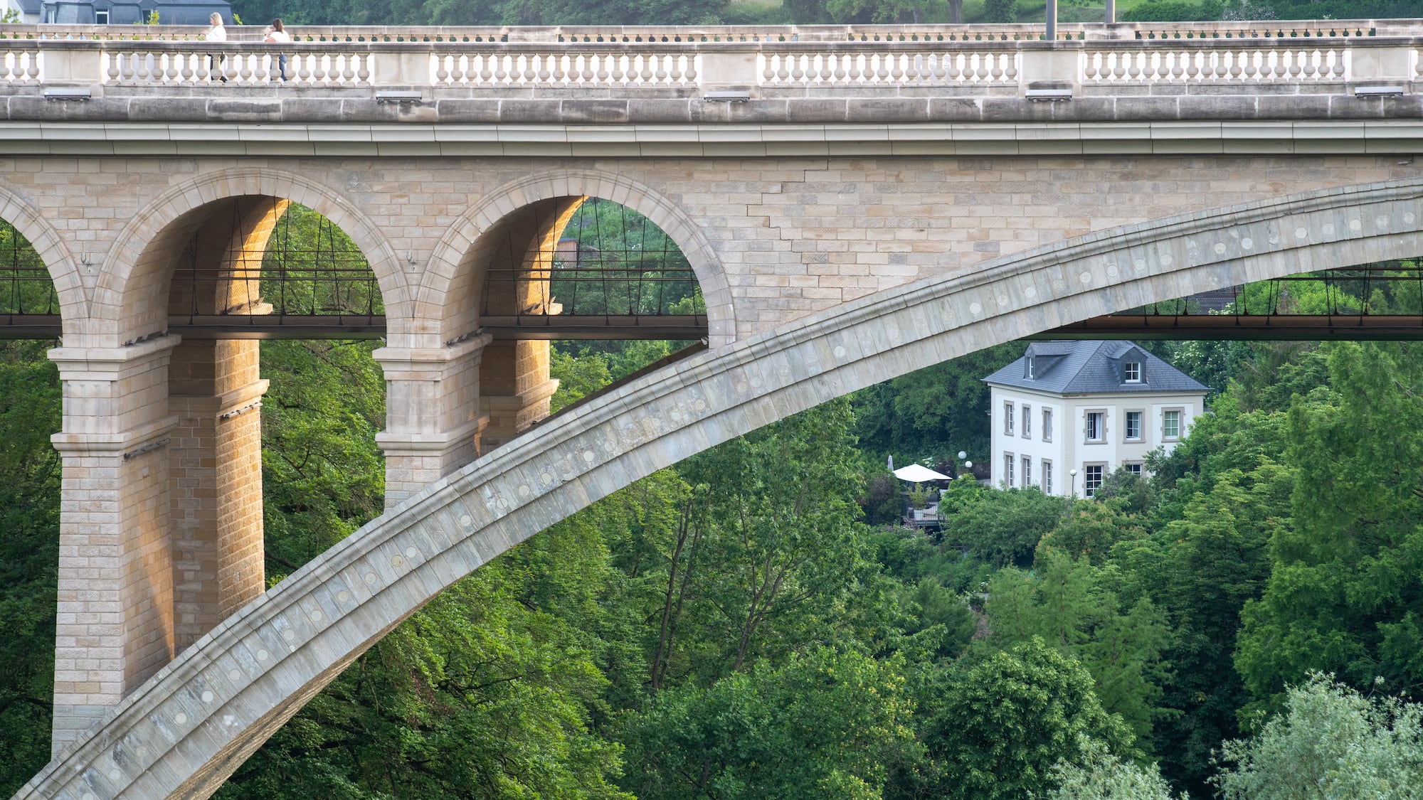a bridge with arches and trees