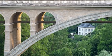 a bridge with arches and trees