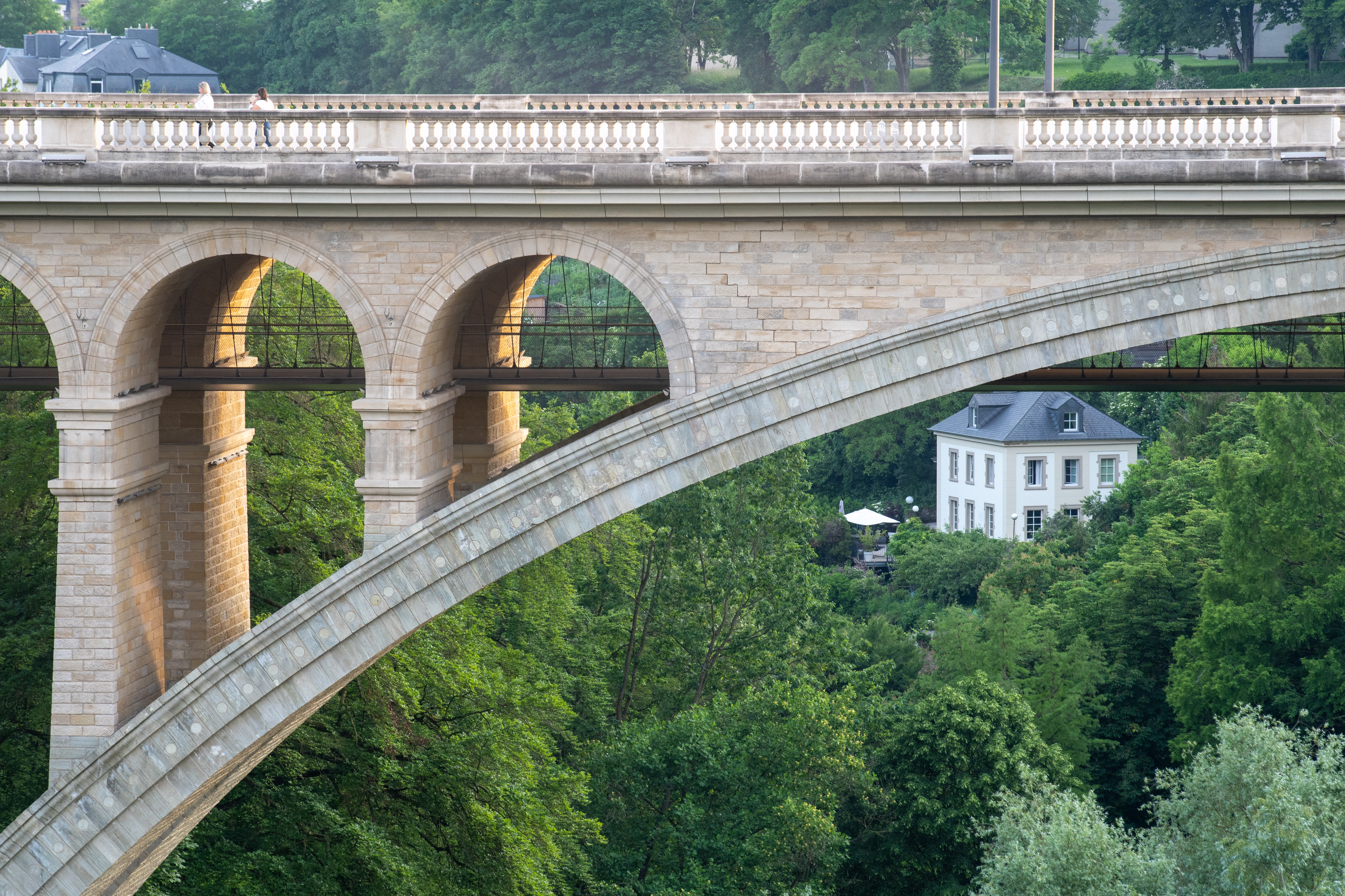 a bridge with arches and trees