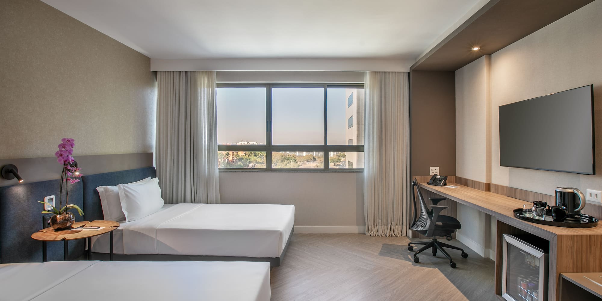 a room with two beds and a desk