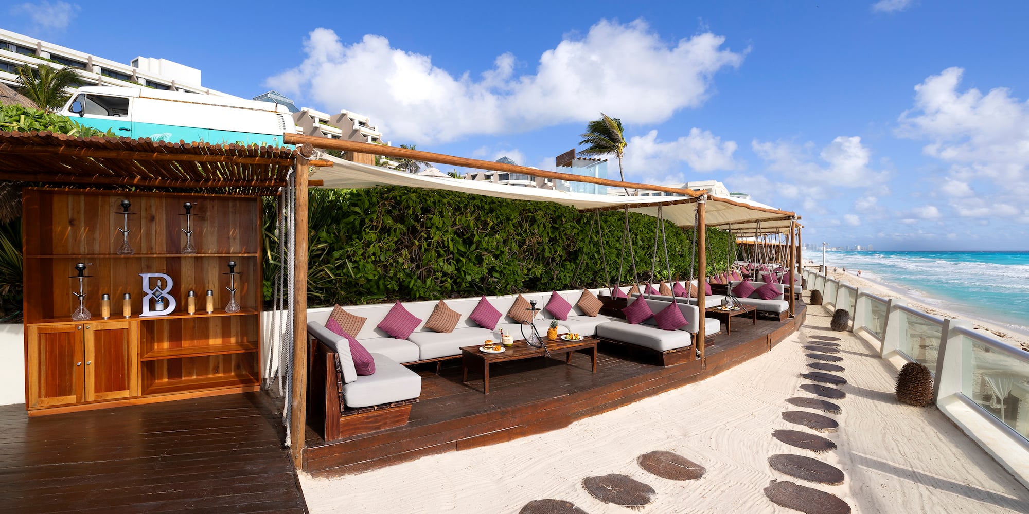 a patio area with a table and chairs on a beach