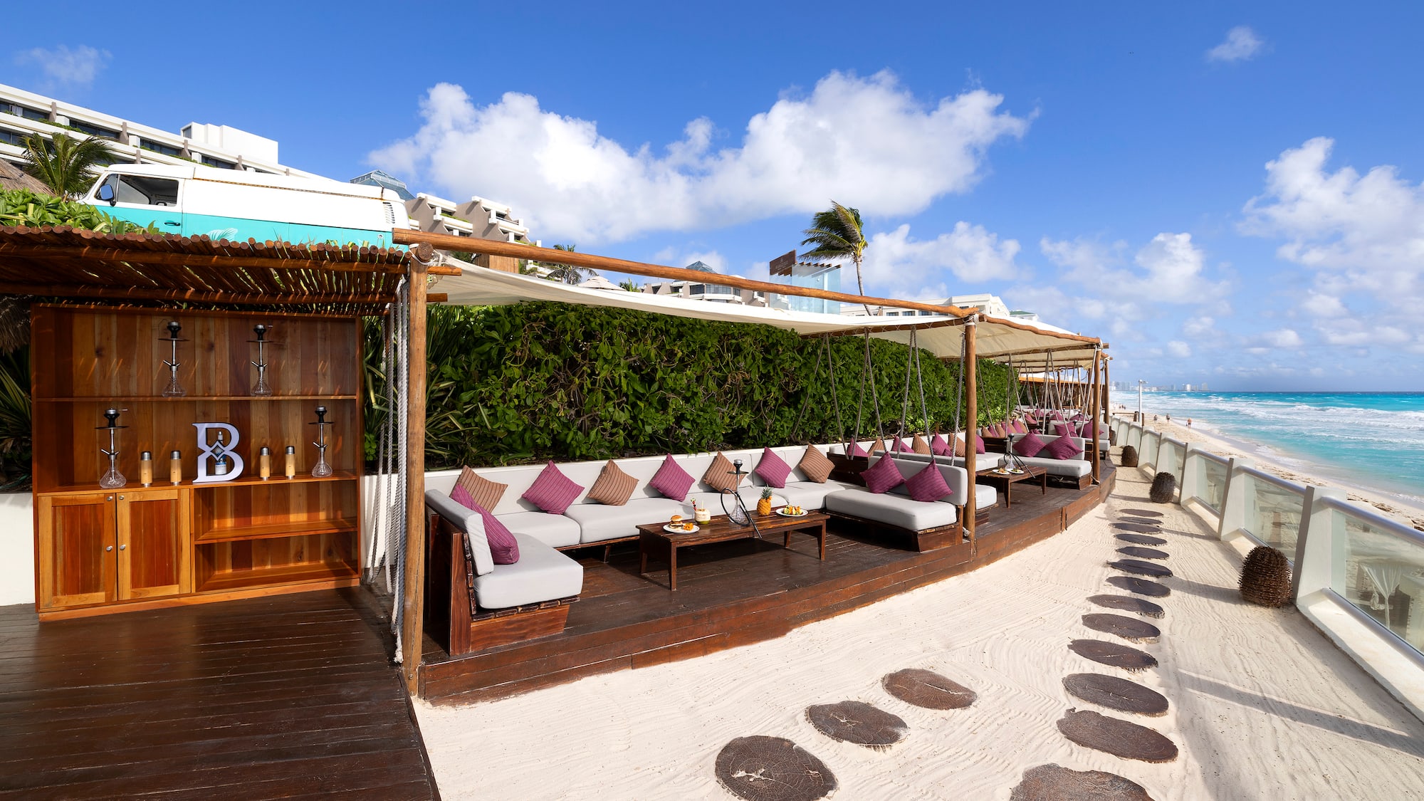 a patio area with a table and chairs on a beach