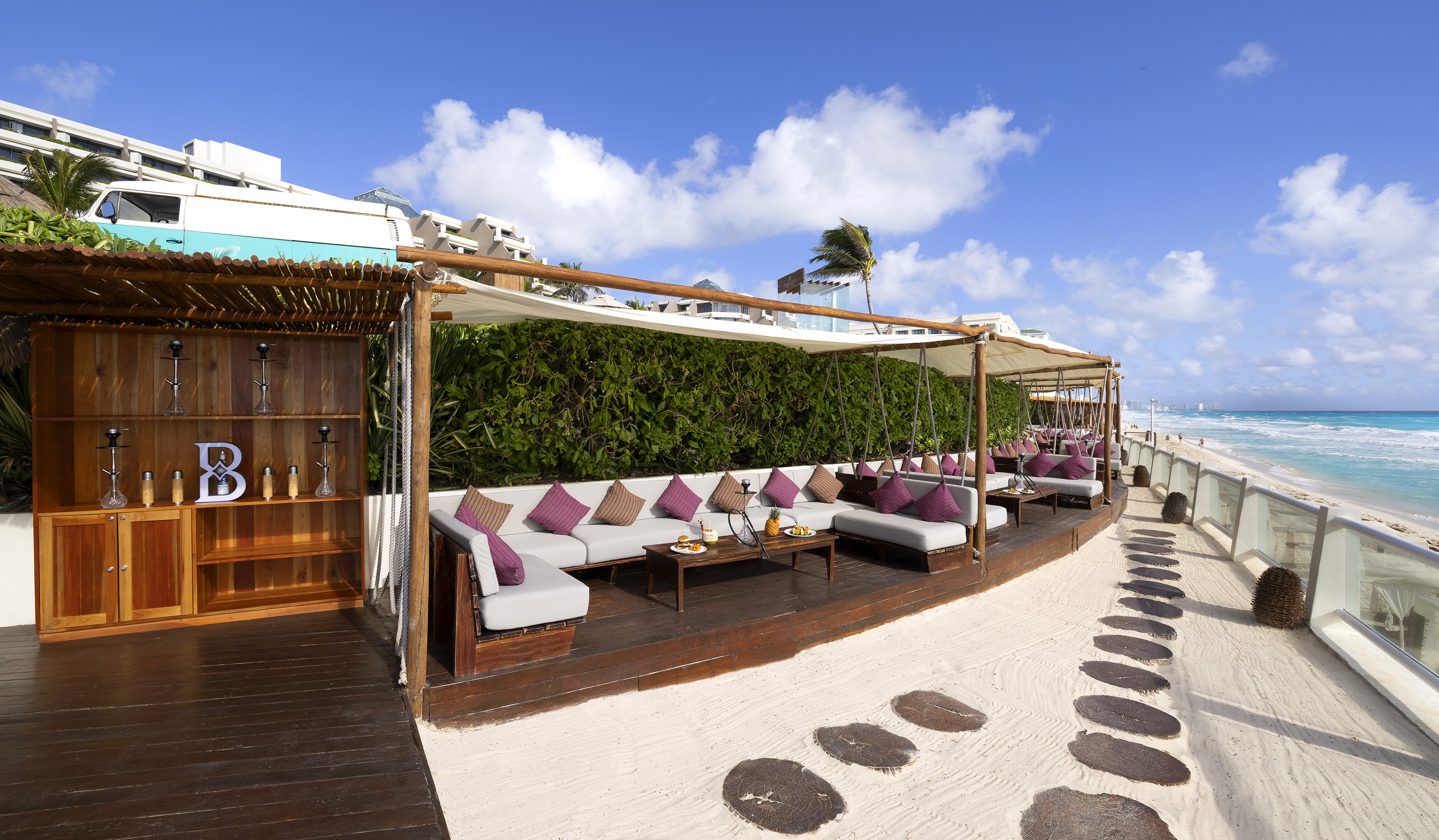 a patio area with a table and chairs on a beach