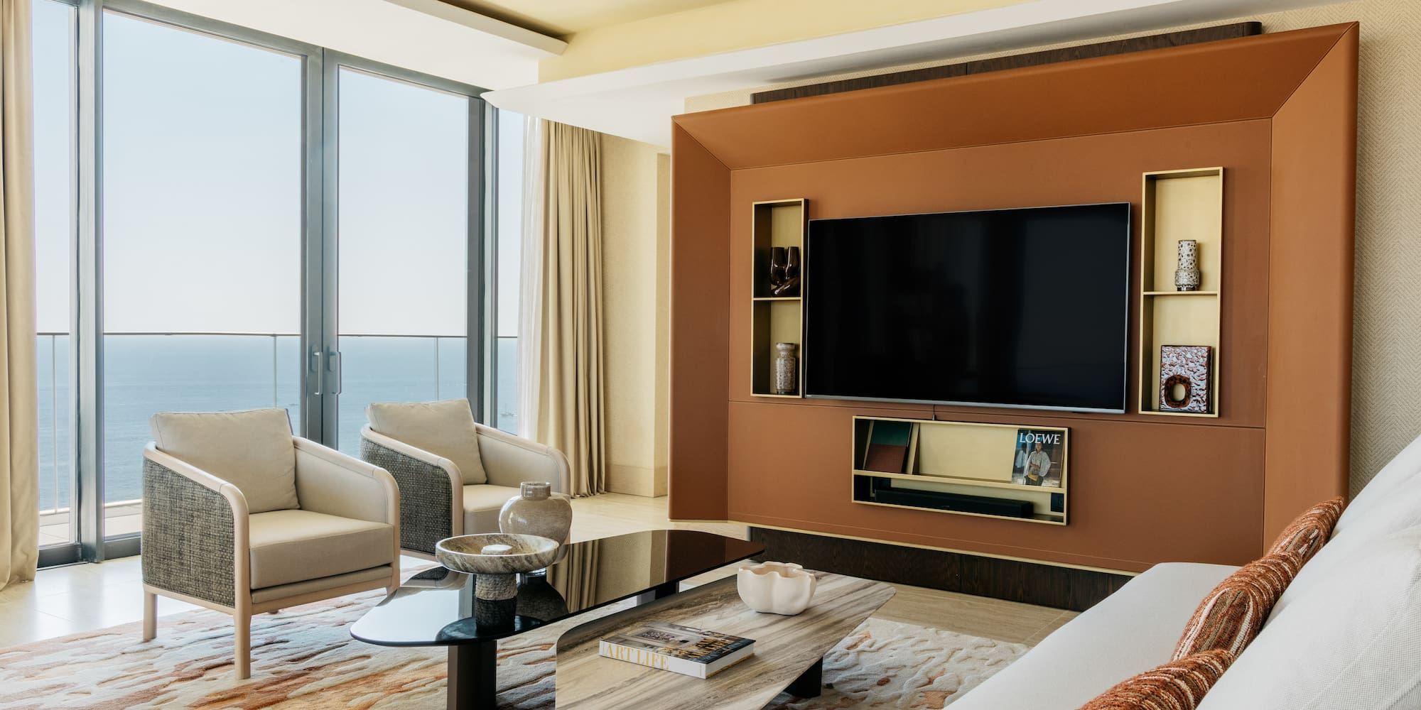 a living room with a large television and a large wall