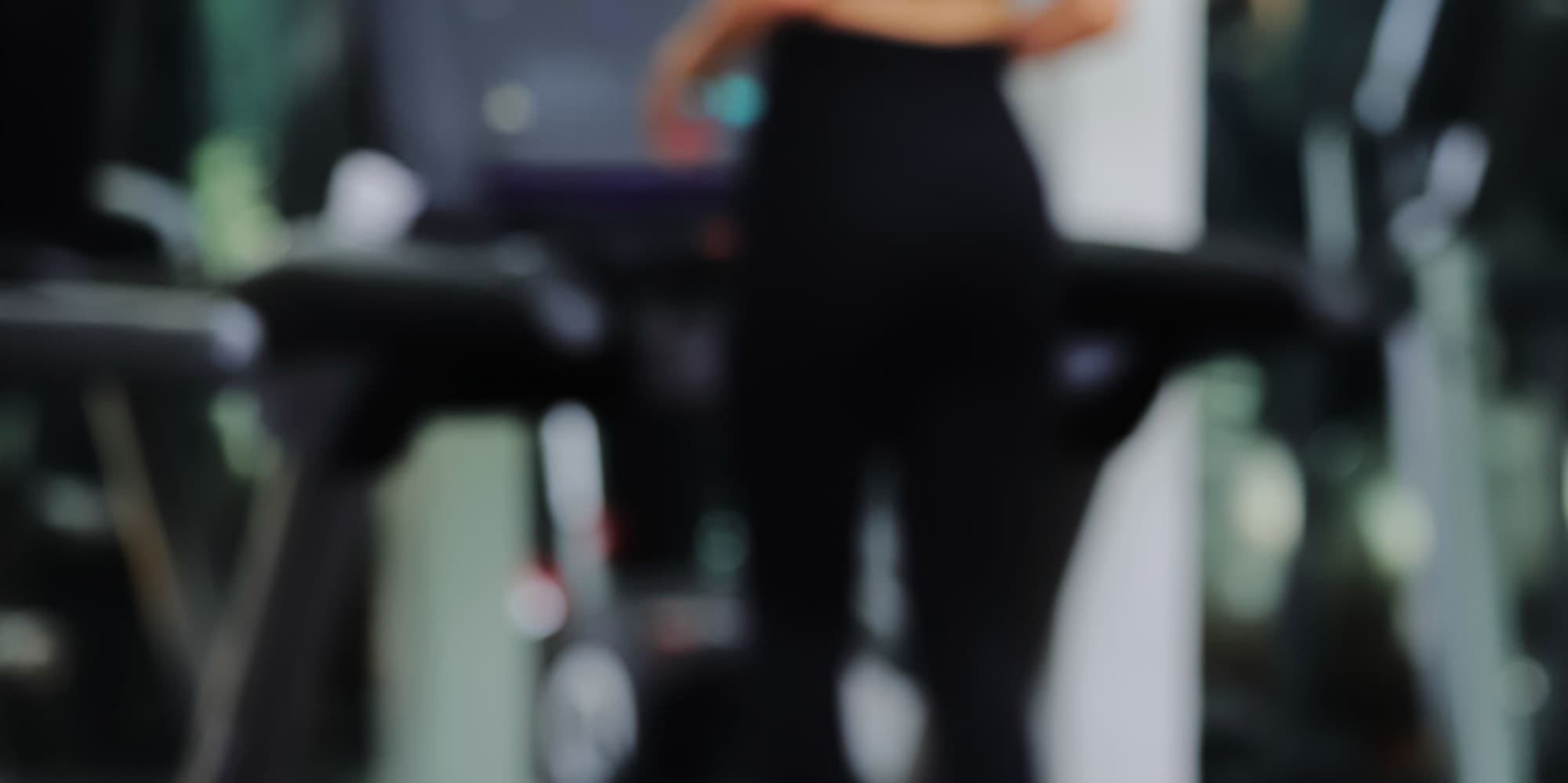 a blurry image of a woman running on a treadmill