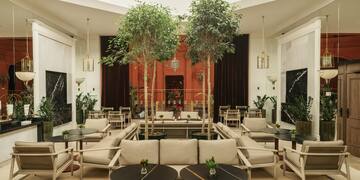 a room with tables and chairs and trees