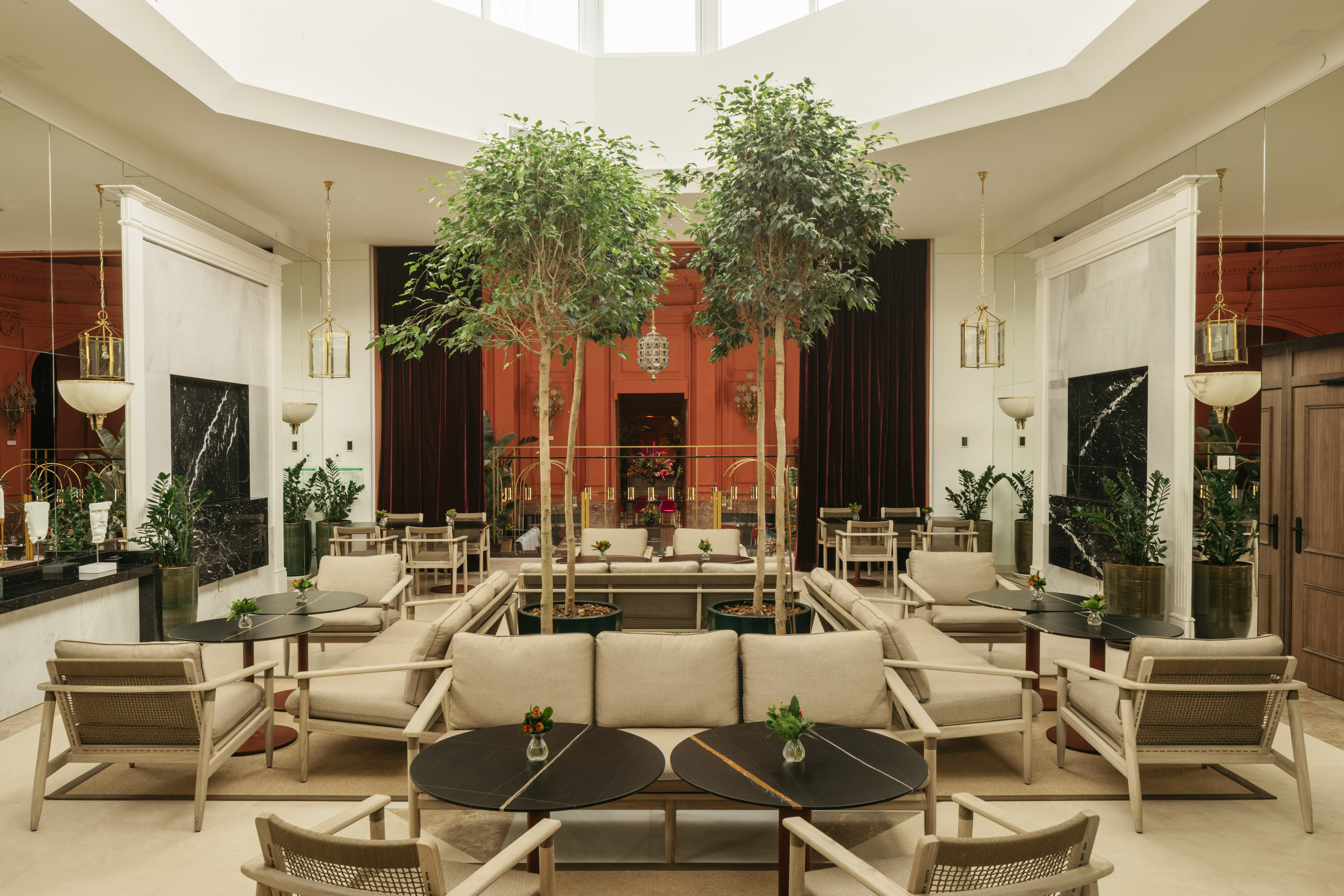 a room with tables and chairs and trees