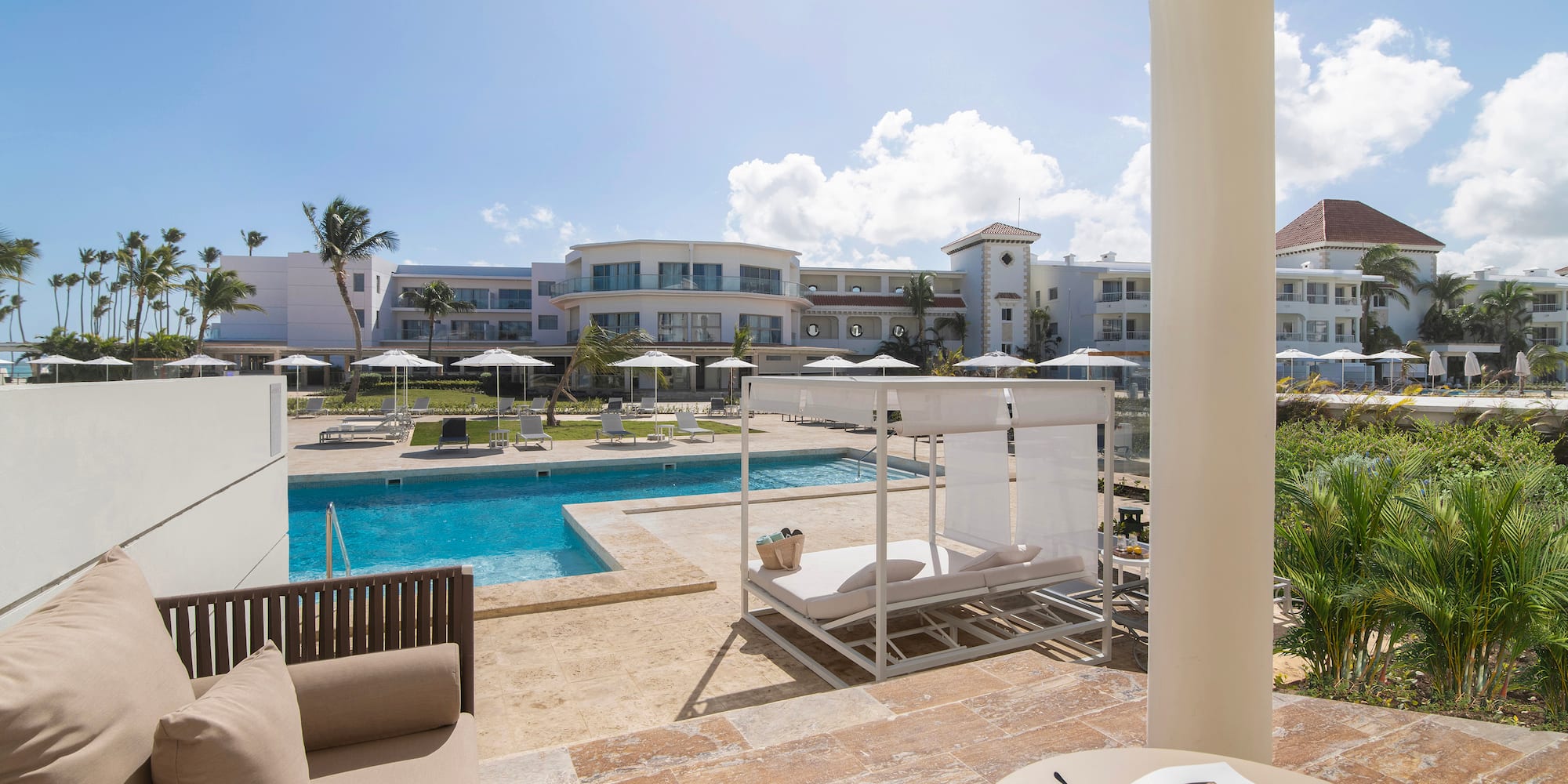 a pool with a couch and a chair