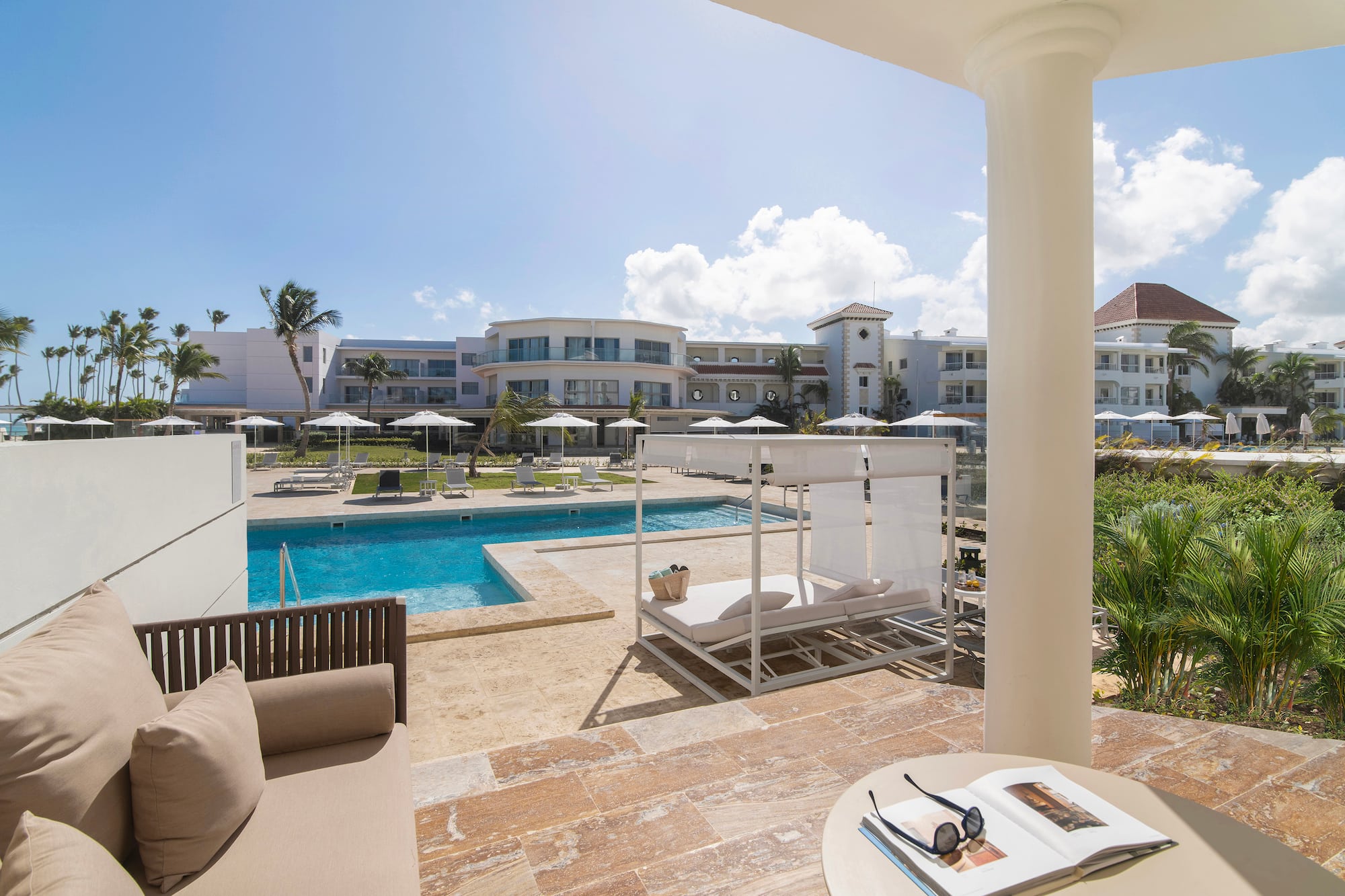 a pool with a couch and a chair