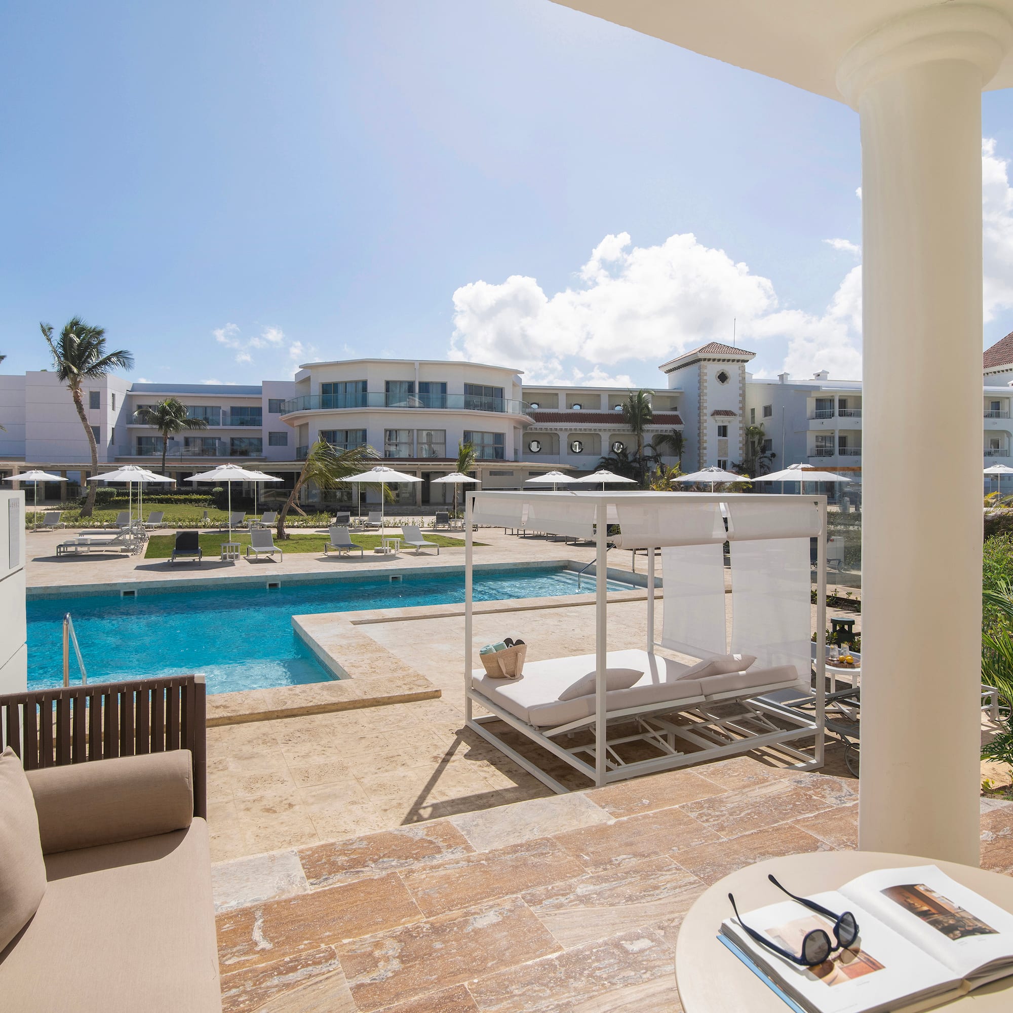a pool with a couch and a chair