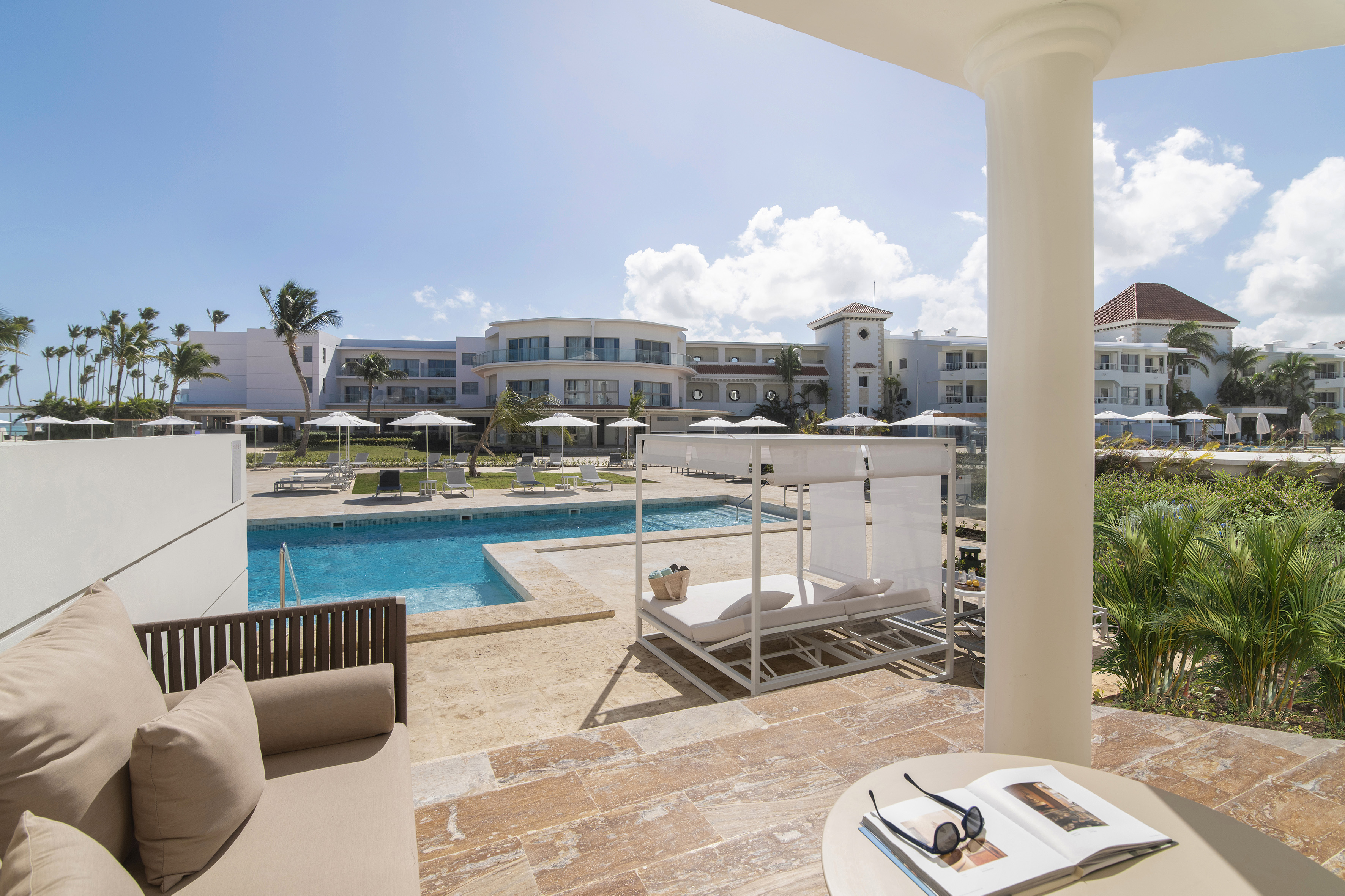 a pool with a couch and a chair
