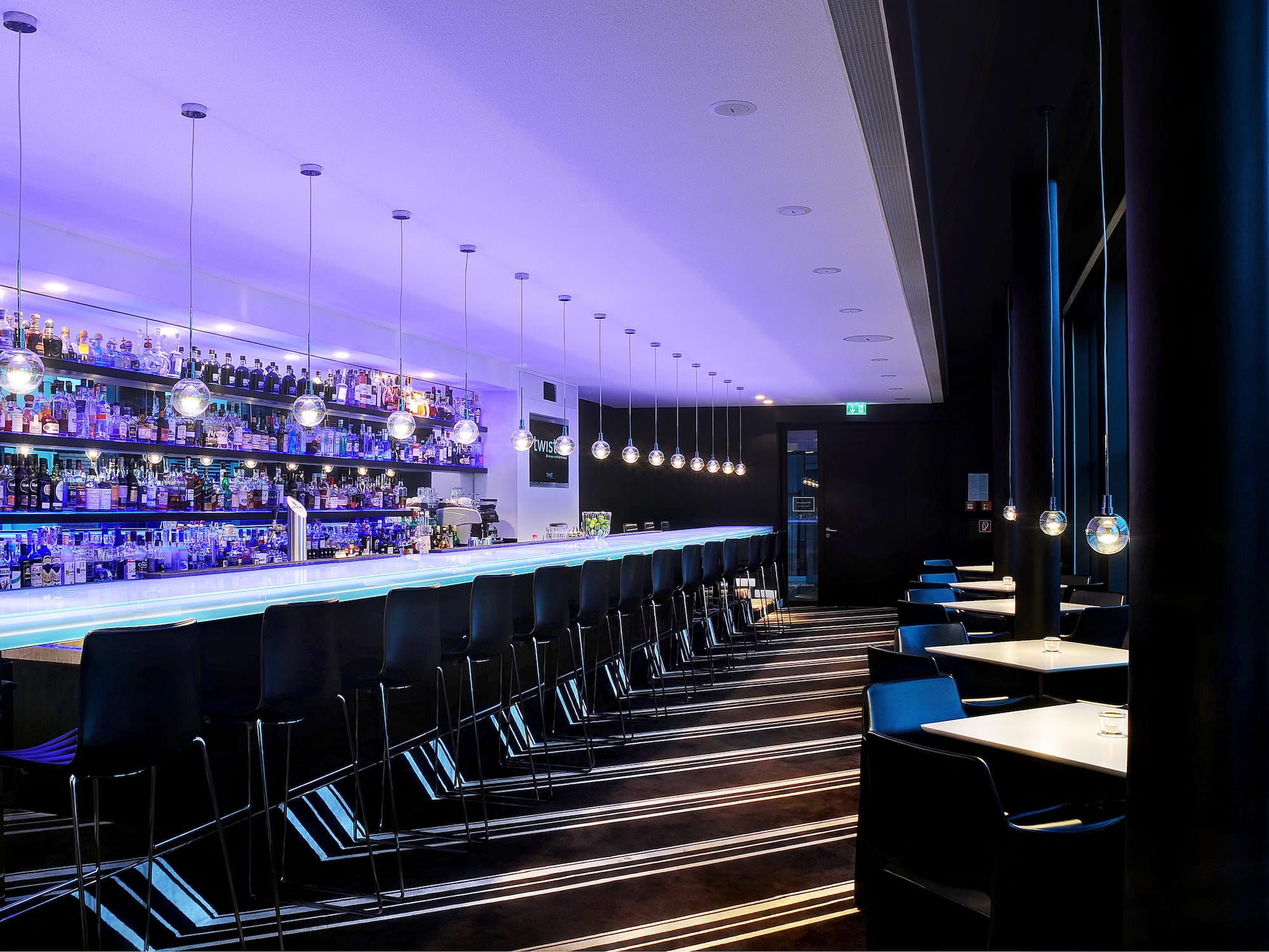 a bar with chairs and lights