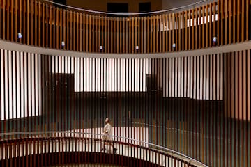 a person standing on a round staircase