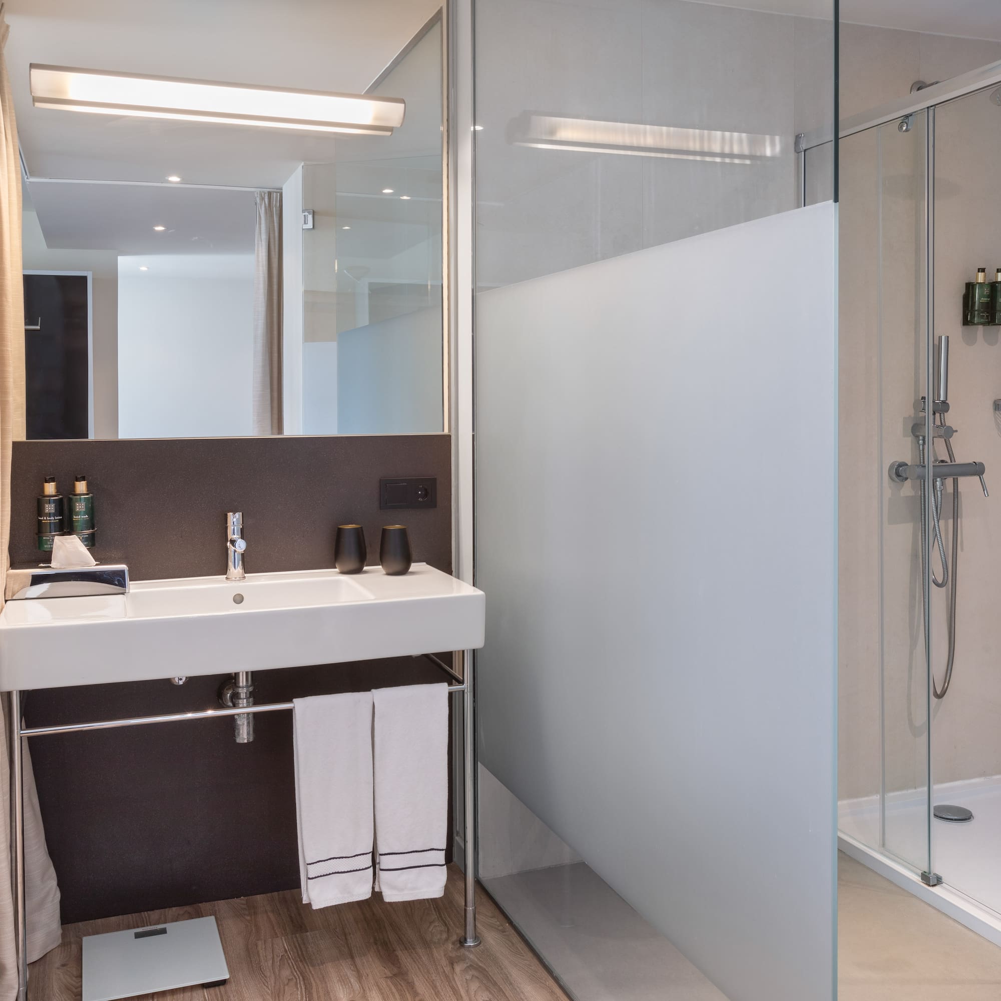 a bathroom with a shower and sink