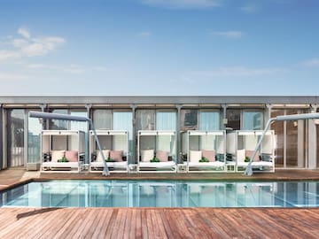 a pool with a deck and chairs