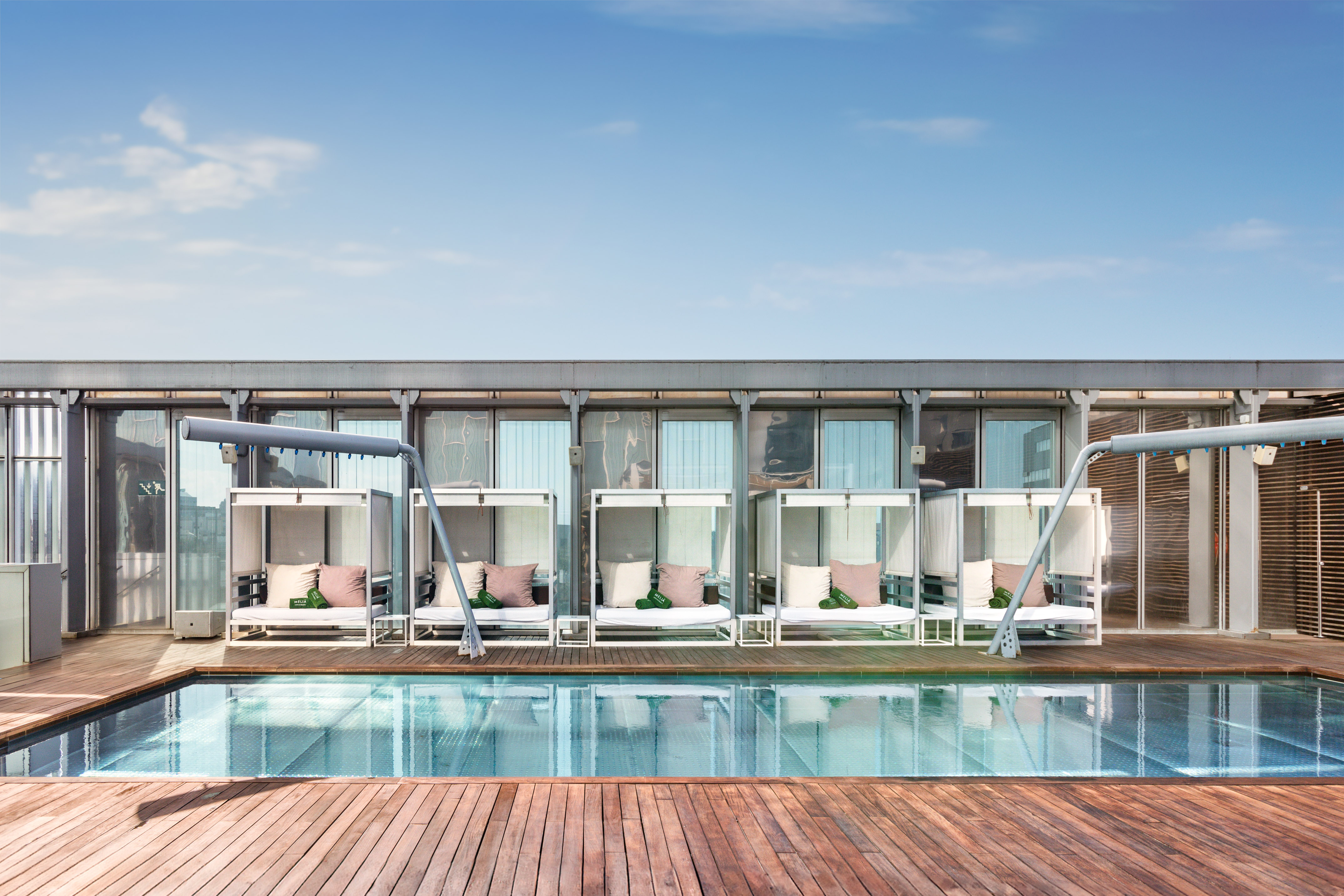 a pool with a deck and chairs