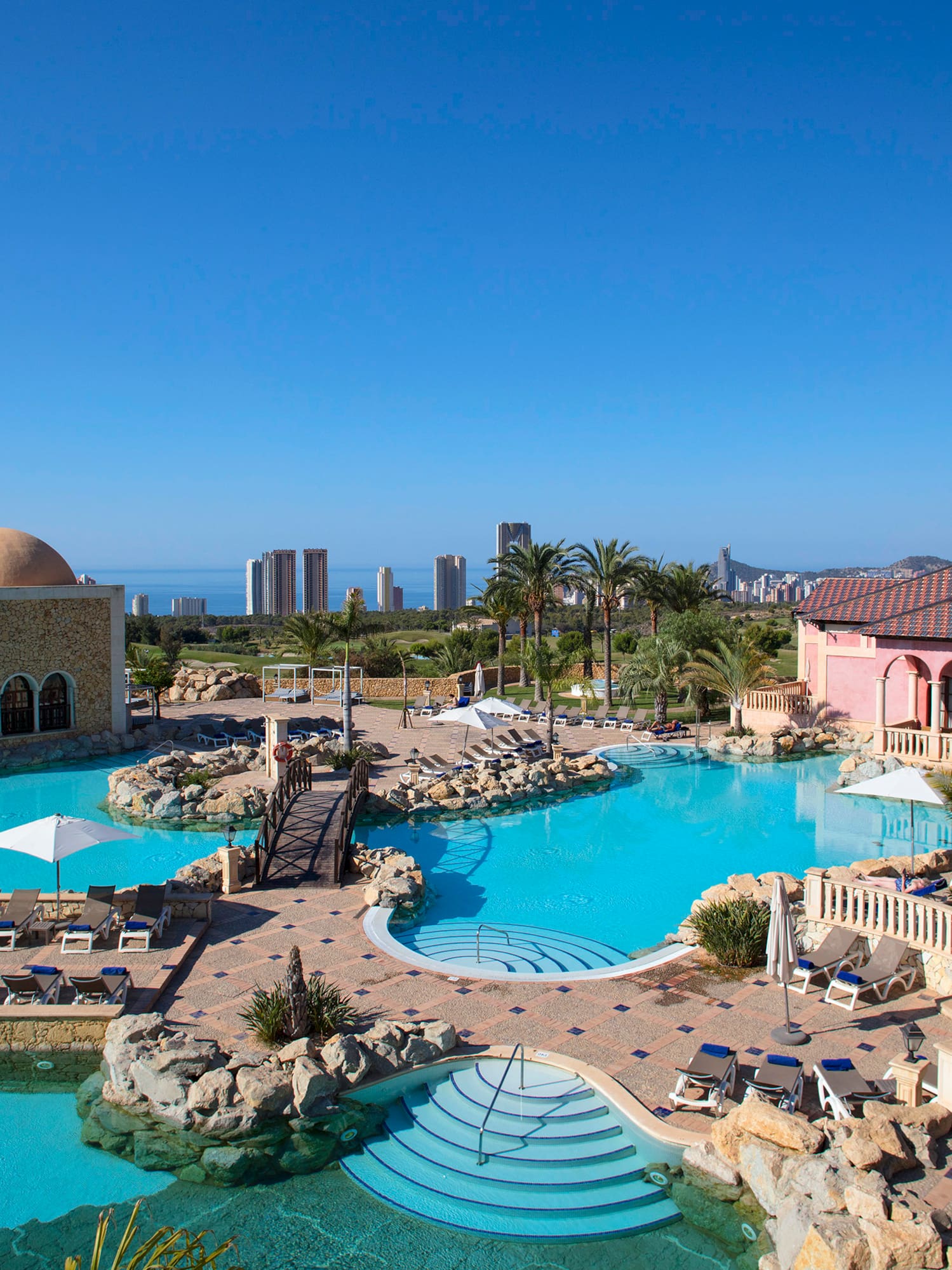 a swimming pool with a large building and a large pool