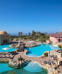 a swimming pool with a large building and a large pool
