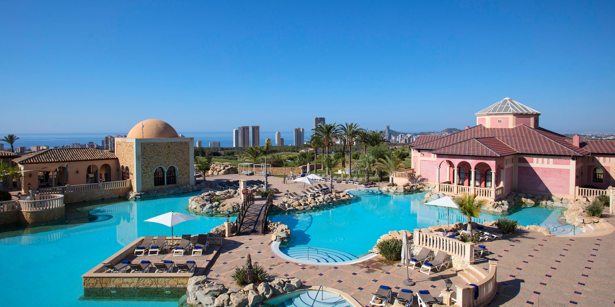 a swimming pool with a large building and a large pool