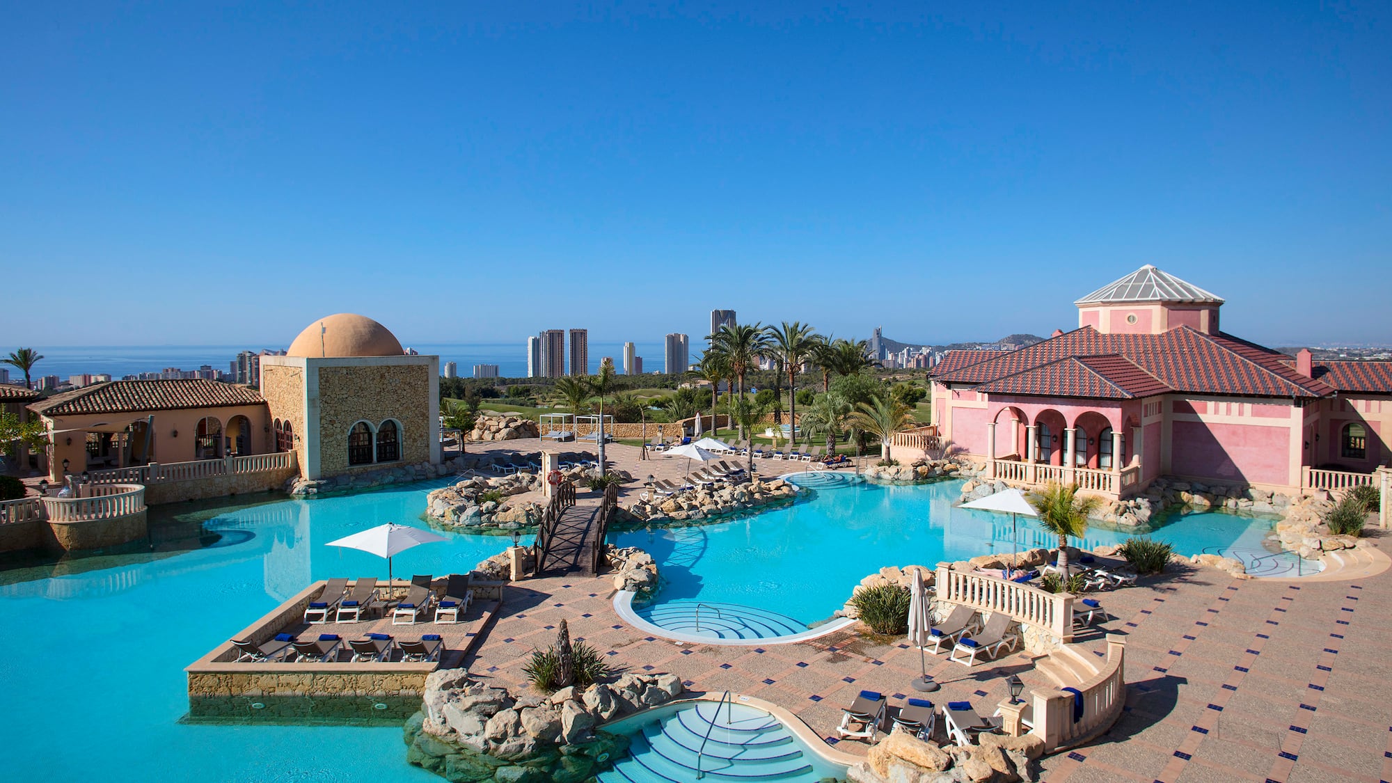 a swimming pool with a large building and a large pool
