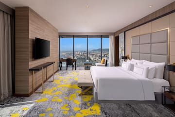 a room with a large window and a bed