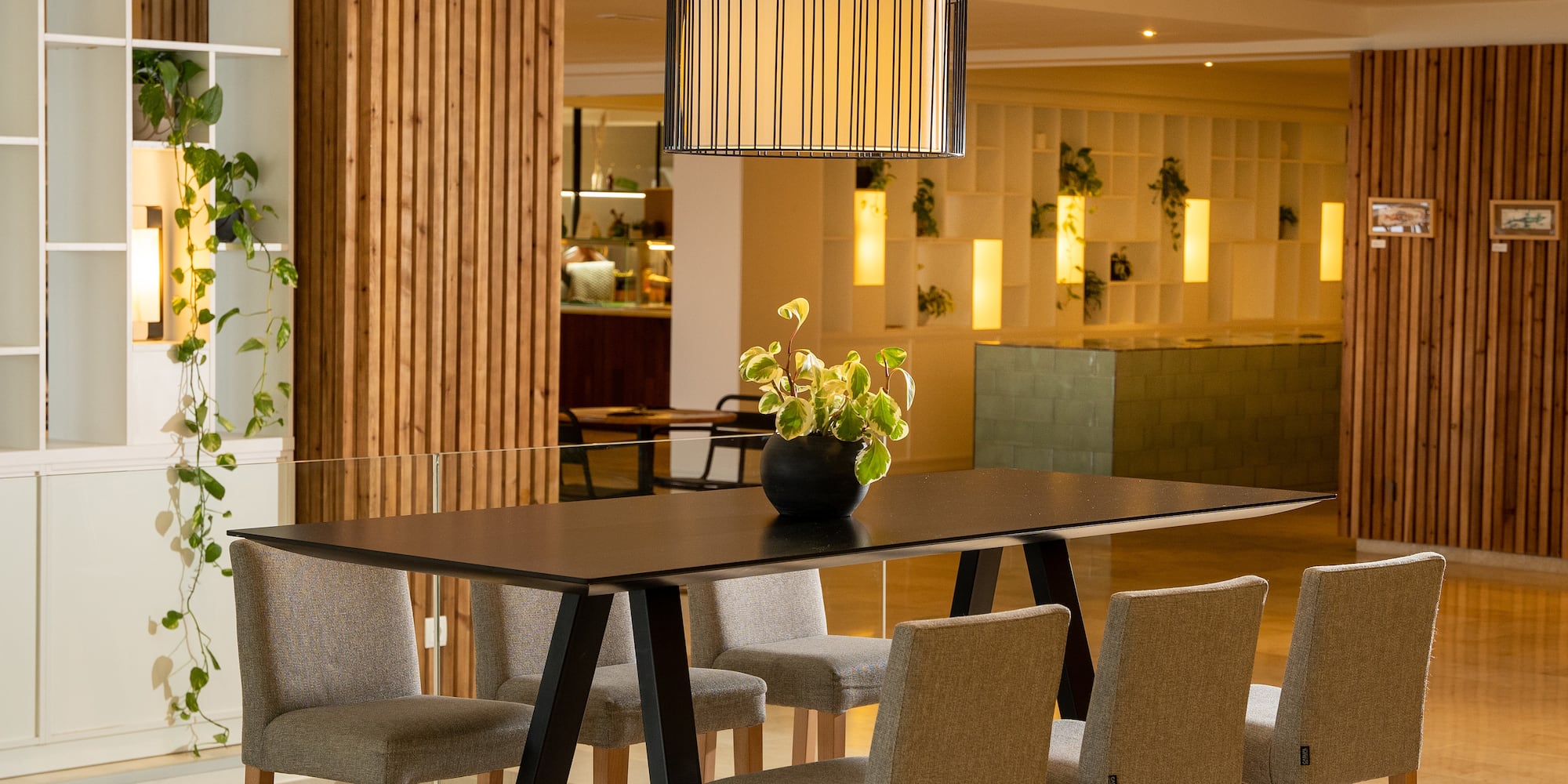 a dining table with chairs and a lamp