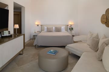 a bedroom with a bed and a couch