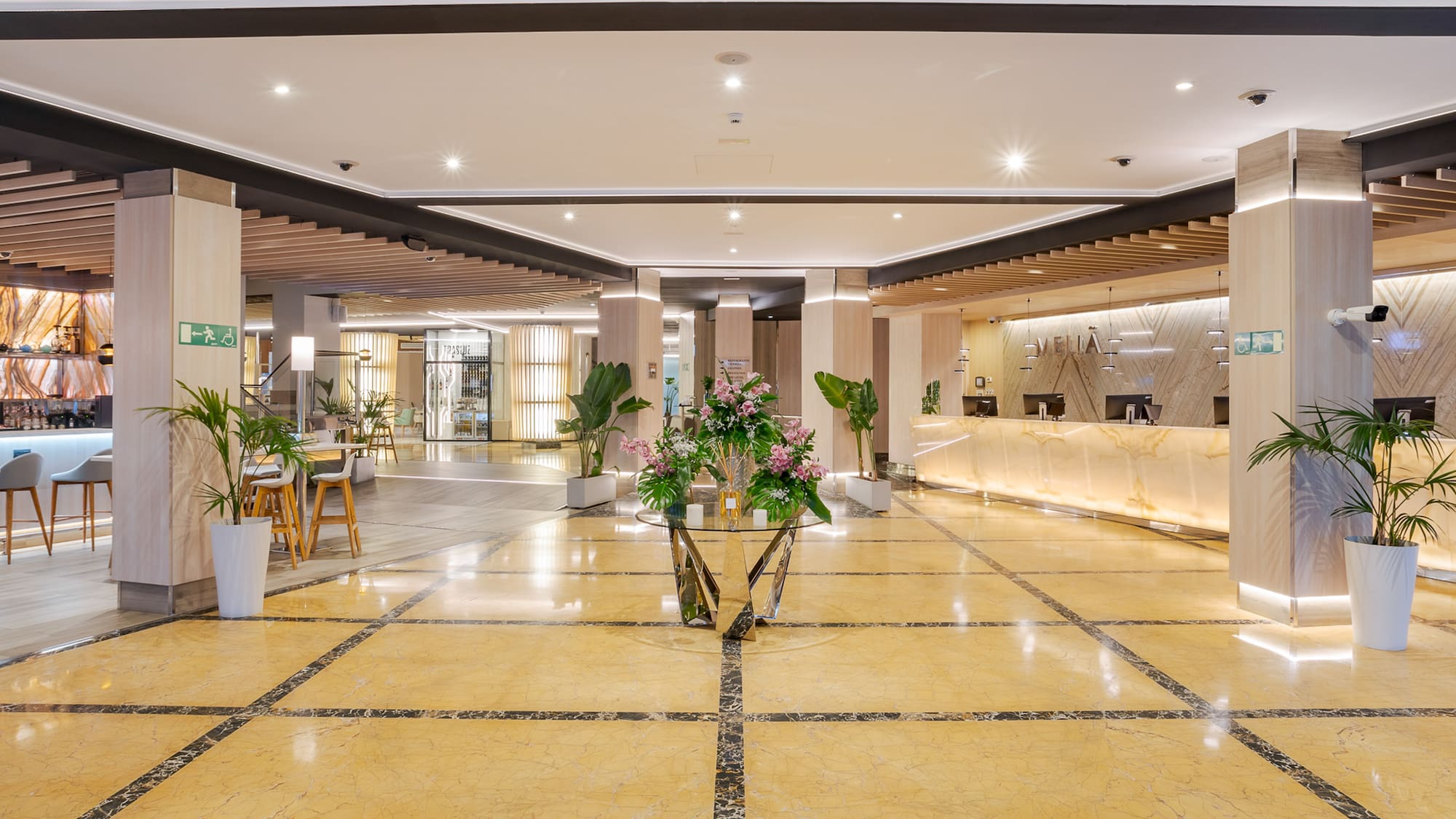 a lobby with a reception desk and flowers