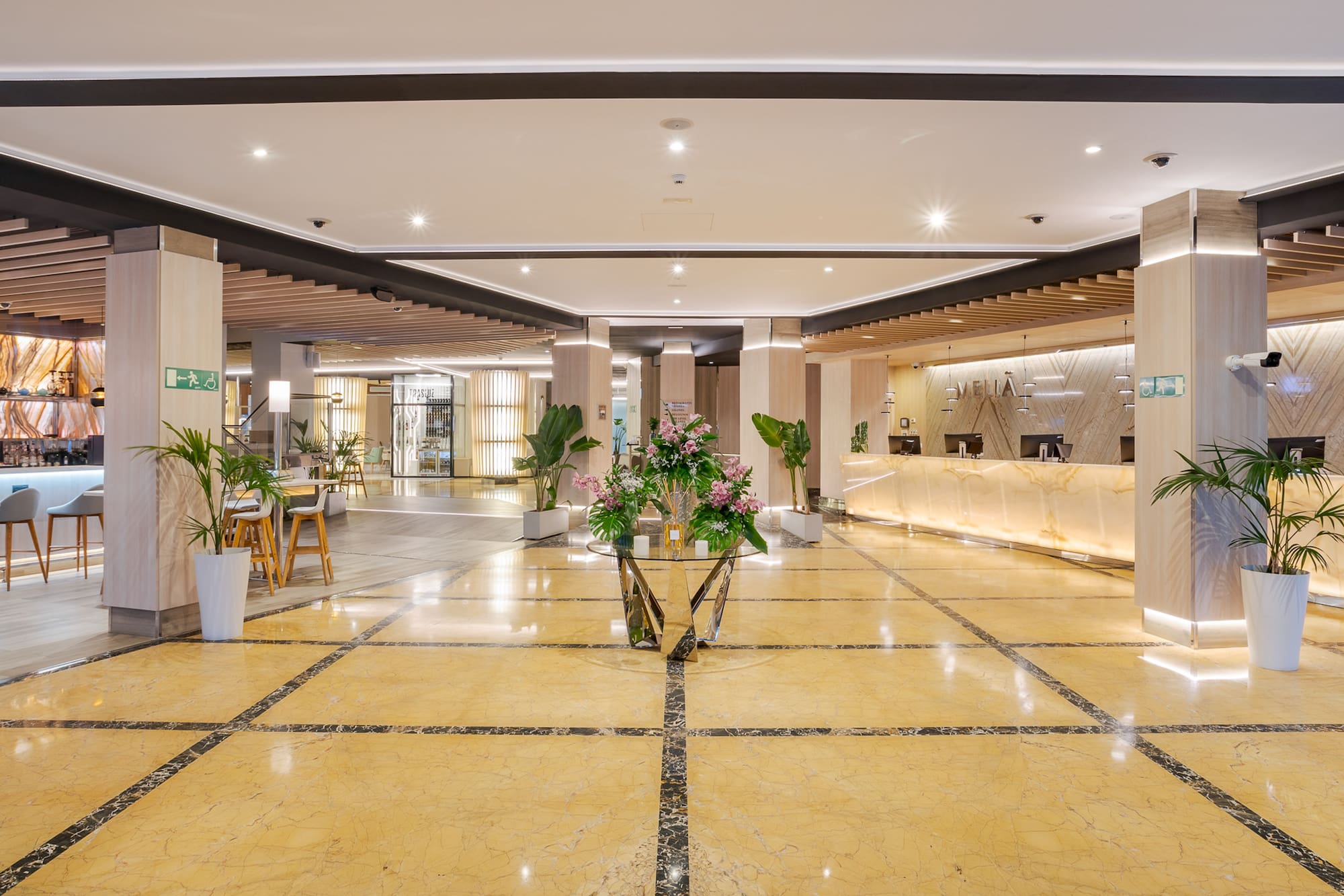 a lobby with a reception desk and flowers
