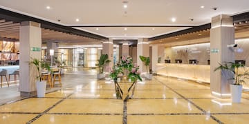 a lobby with a reception desk and flowers