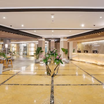 a lobby with a reception desk and flowers