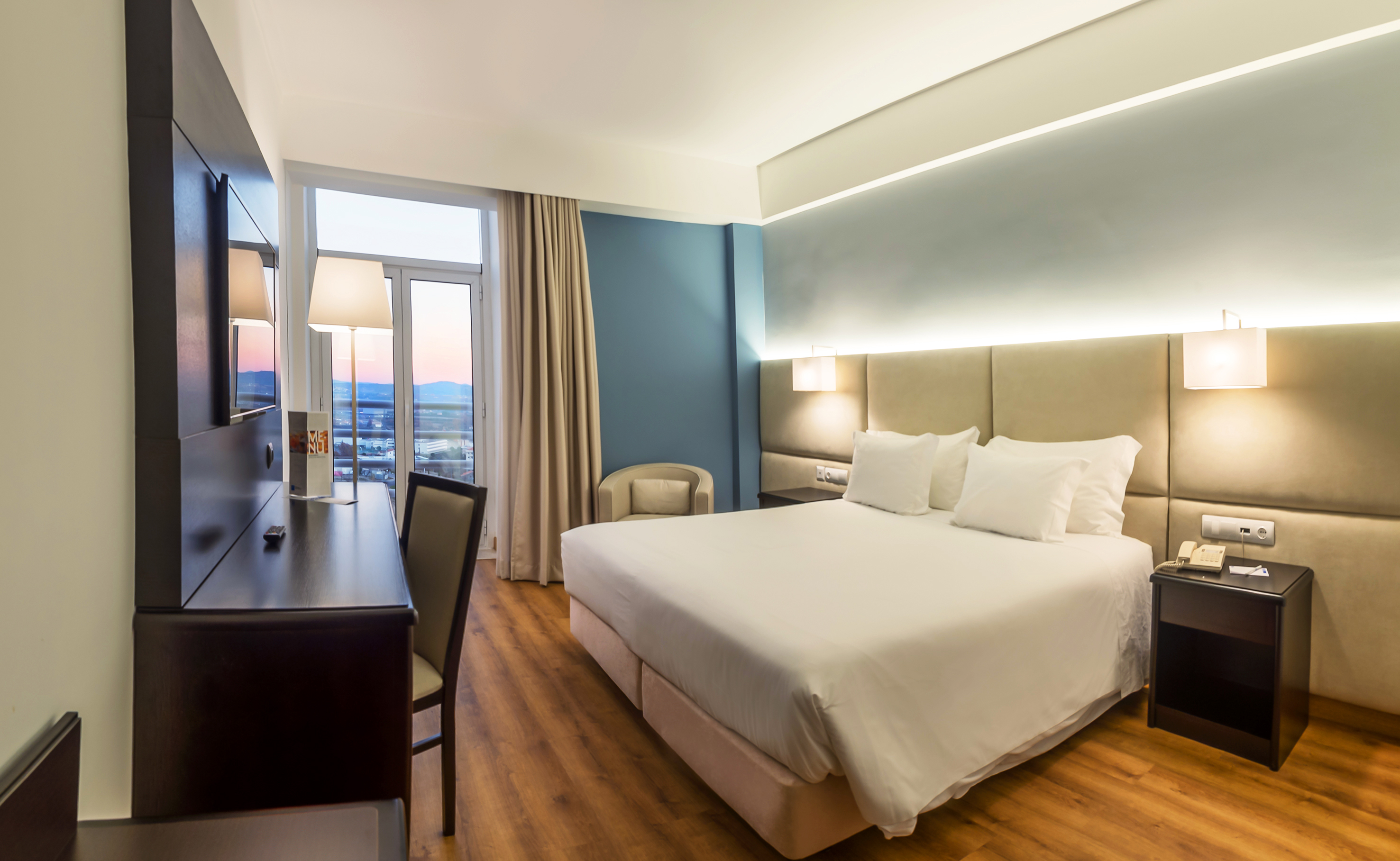 a room with a bed and a desk