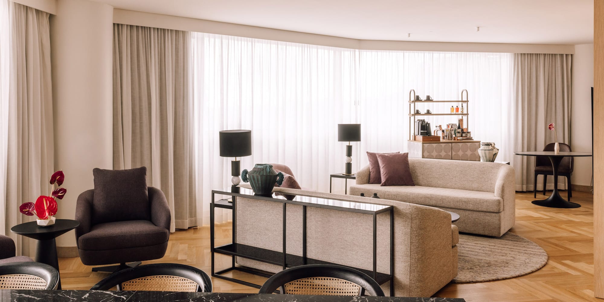 a living room with a black marble table and couches