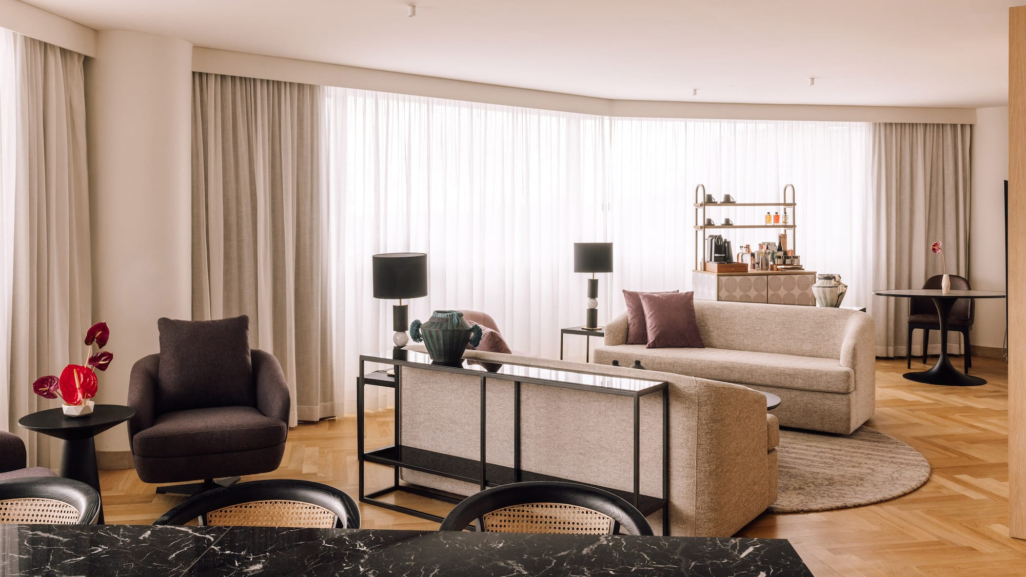a living room with a black marble table and couches