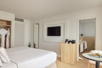 a room with a bed and a tv