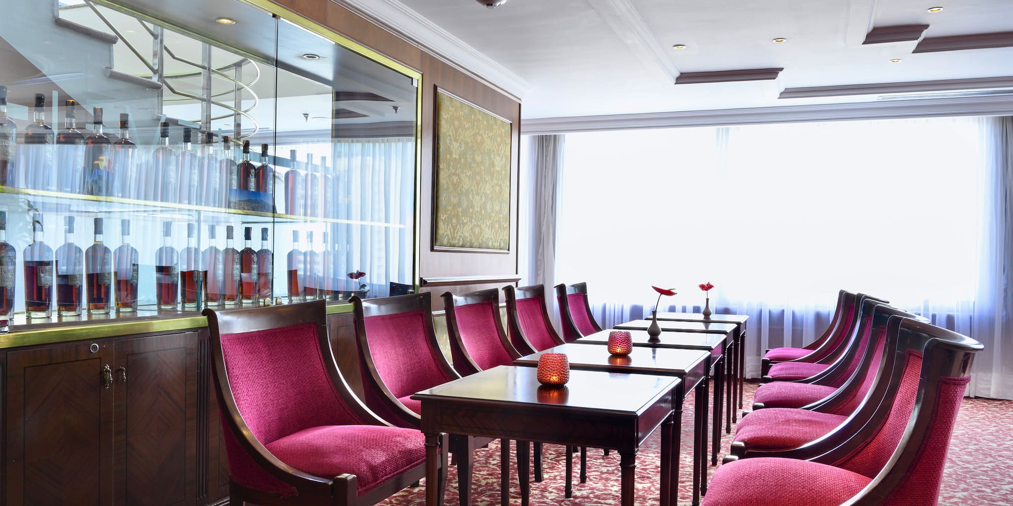 a room with red chairs and tables