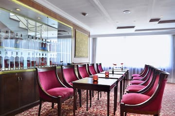 a room with red chairs and tables