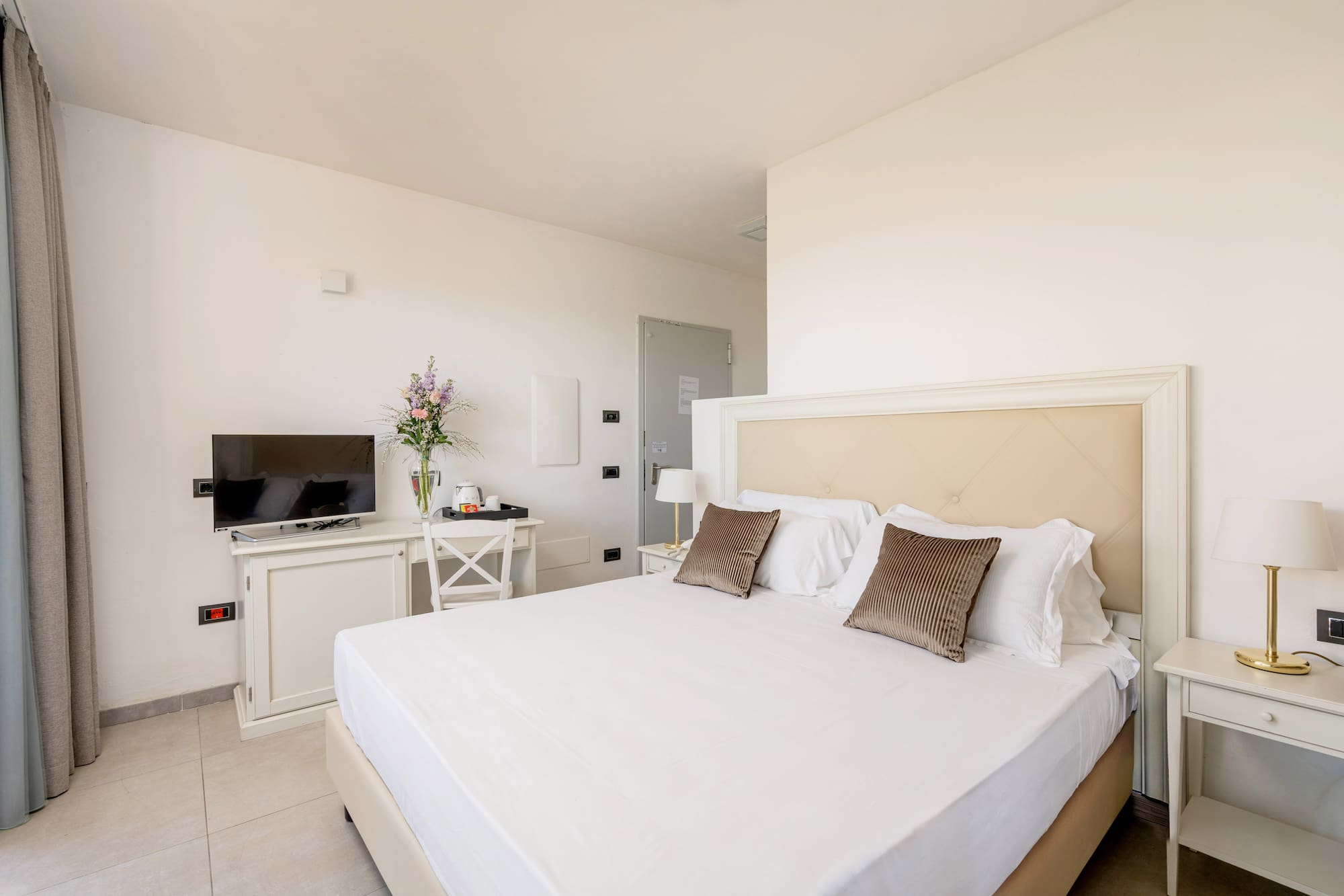 a bed with pillows and a tv in a room