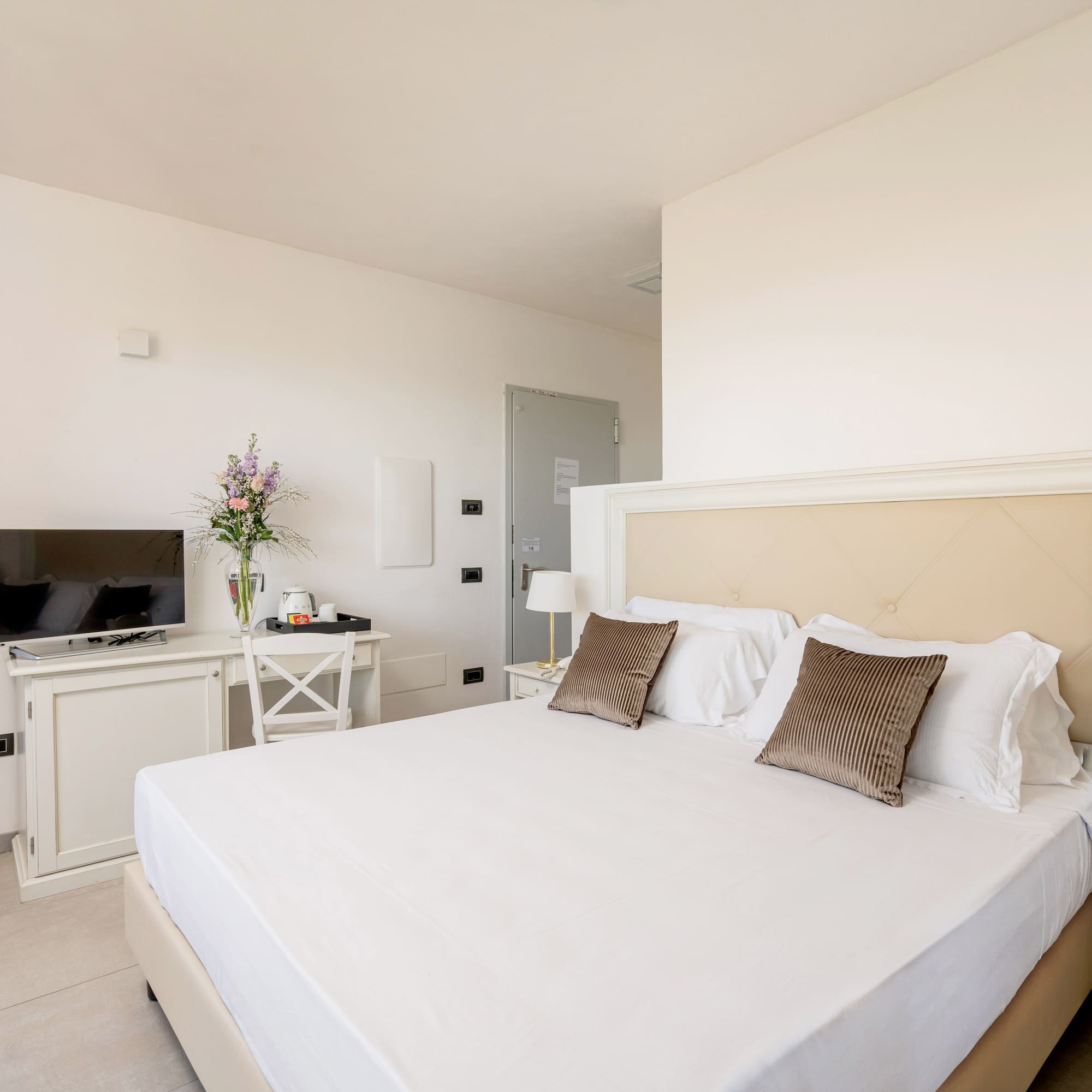 a bed with pillows and a tv in a room