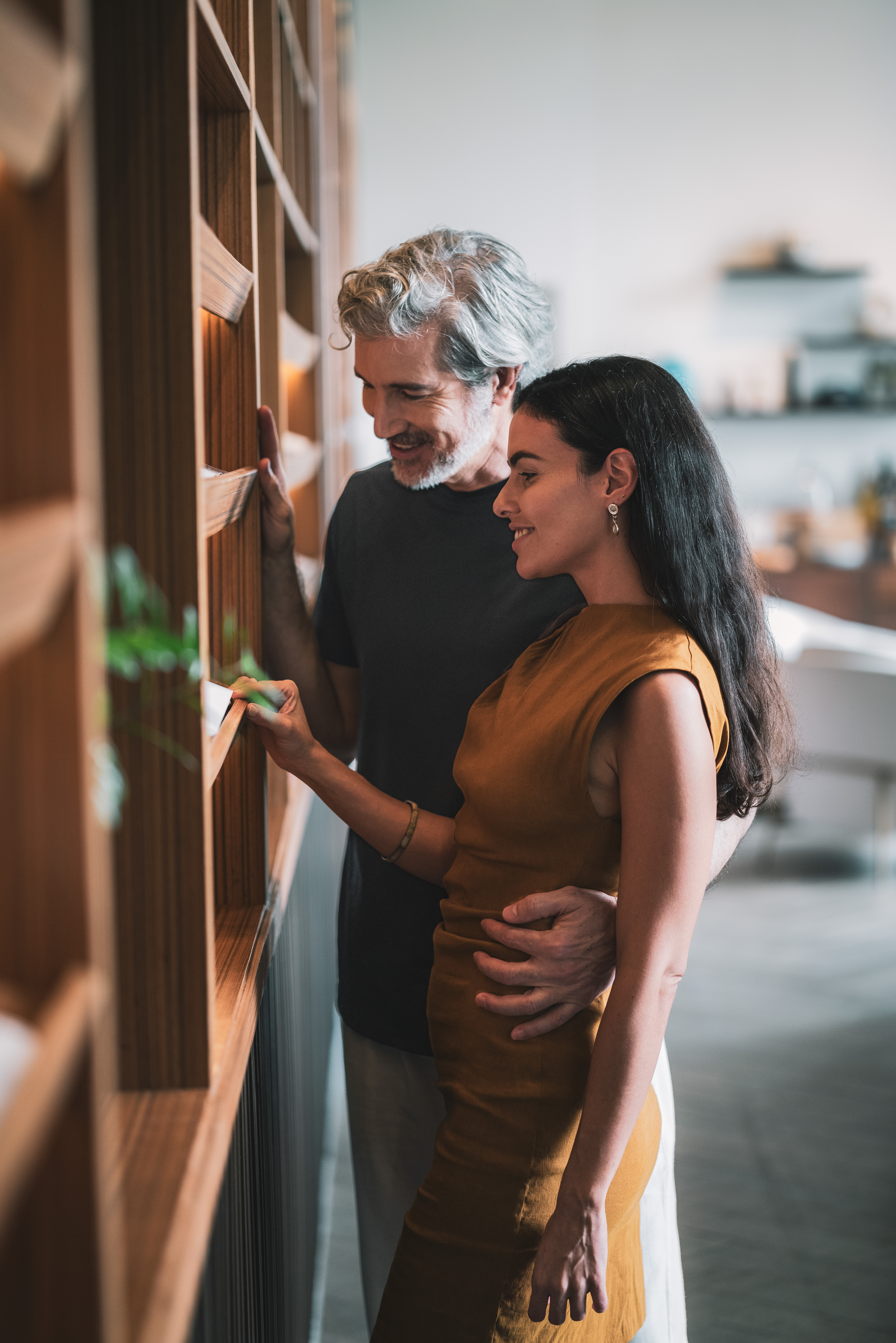 a man and woman looking at a shelf